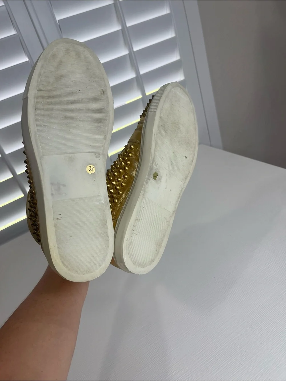 Metallic Gold High-Top Sneakers with Stud Details by Rodney P. Hunt
